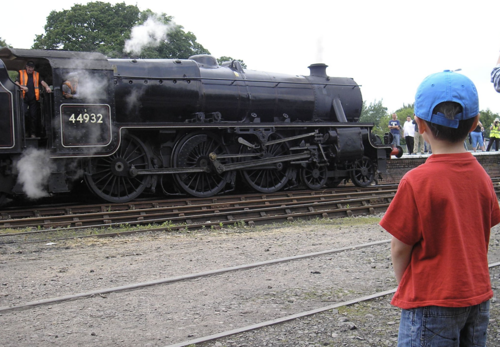Boy watched large black steam train at Yeovil Railways Centre