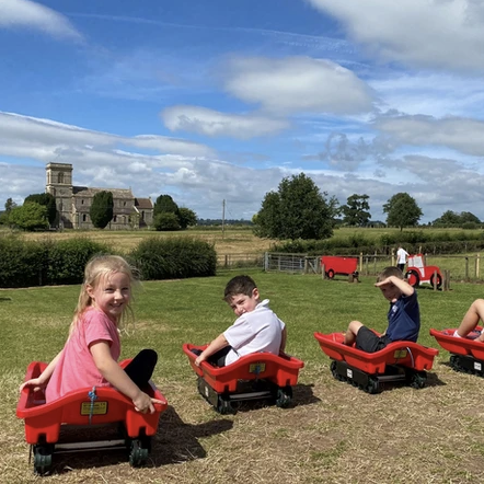 Children sit aboard go-karts at Farrington's Farm