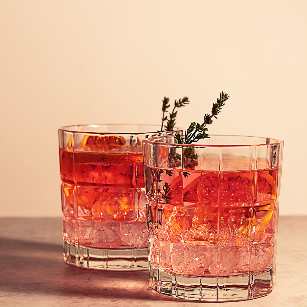 Two drinks cocktails featuring sprigs of thyme 