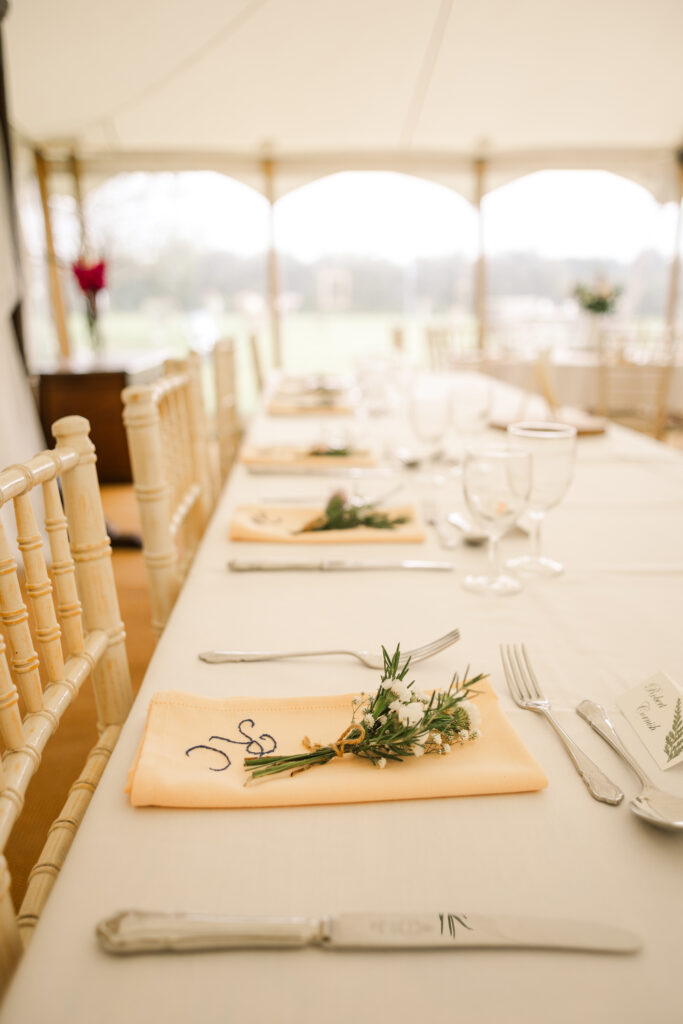 Spring wedding place setting with personalised napkin and posy of flowers