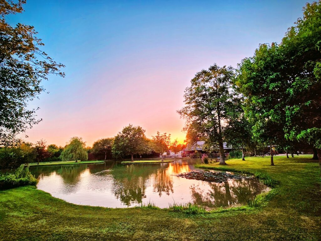 Sunset over a picturesque lakeside wedding venue - Yarlington Park 